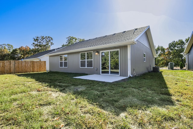 back of property featuring a patio, central AC, and a yard