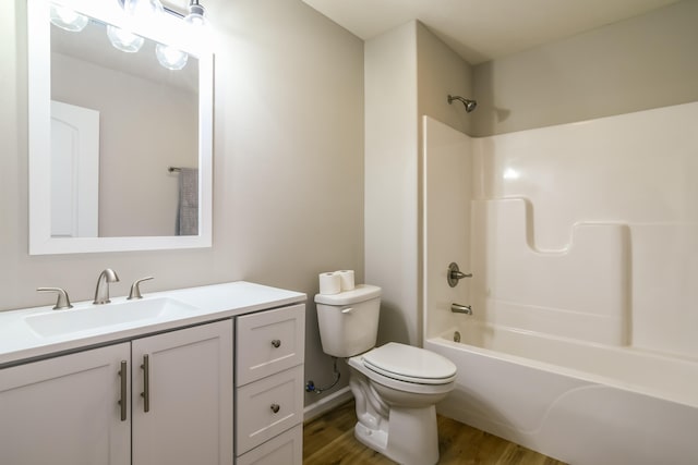 full bathroom featuring toilet, bathtub / shower combination, hardwood / wood-style floors, and vanity