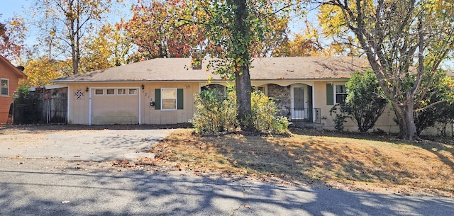 ranch-style house with covered porch and a garage