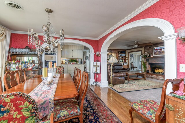 15778 Lawrence Unit 2130, Mount Vernon, MO 65712 - dining area with arched walkways, ceiling fan, ornate columns, wood finished floors, and a chandelier