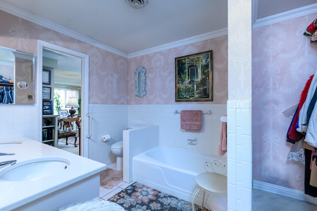 bathroom featuring toilet, a washtub, ornamental molding, sink, and tile walls