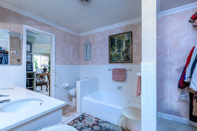 15778 Lawrence Unit 2130, Mount Vernon, MO 65712 - full bathroom featuring toilet, wallpapered walls, tile walls, a garden tub, and wainscoting