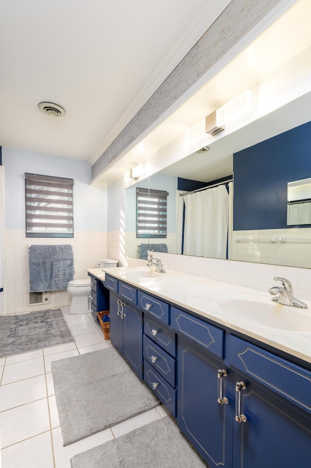15778 Lawrence Unit 2130, Mount Vernon, MO 65712 - bathroom with tile walls, tile patterned floors, a wainscoted wall, double vanity, and toilet