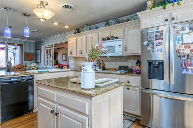 kitchen featuring kitchen peninsula, dishwasher, pendant lighting, light hardwood / wood-style floors, and stainless steel refrigerator with ice dispenser