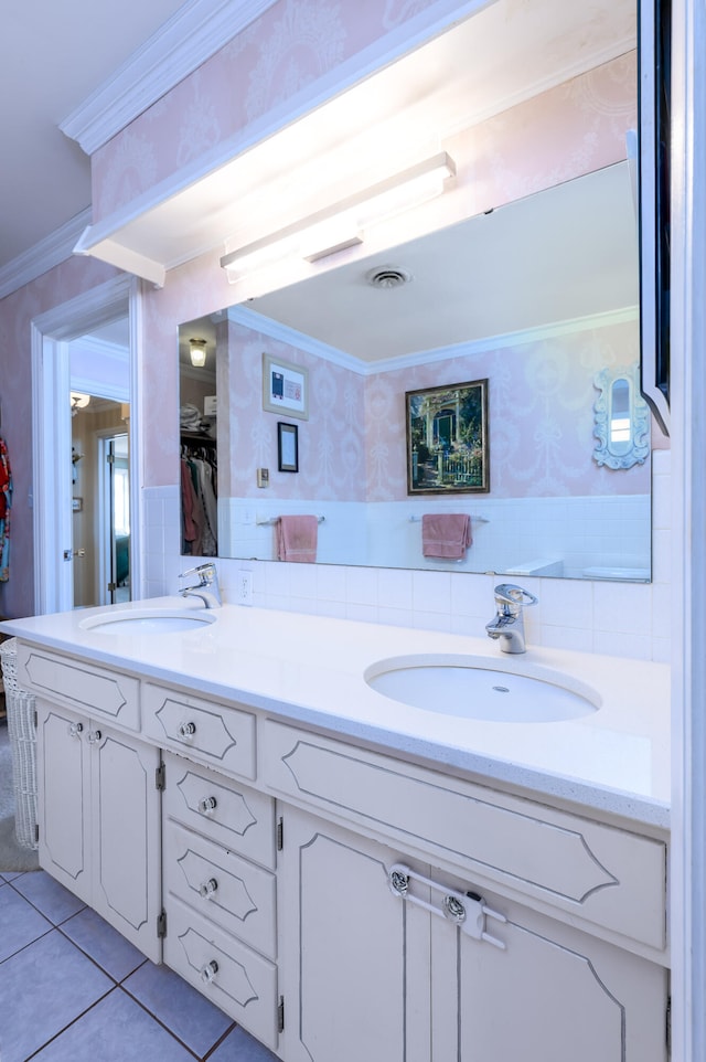 bathroom with vanity, crown molding, and tile patterned flooring