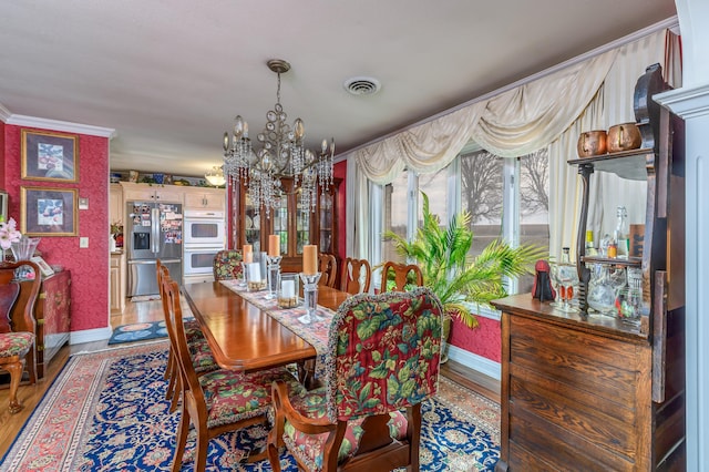 15778 Lawrence Unit 2130, Mount Vernon, MO 65712 - dining space with a chandelier, baseboards, wood finished floors, and crown molding