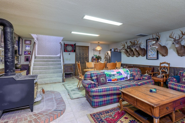 15778 Lawrence Unit 2130, Mount Vernon, MO 65712 - living area featuring a wood stove, a textured ceiling, stairs, and light tile patterned floors