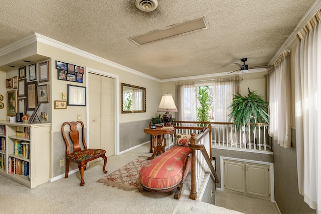 sitting room with light carpet, crown molding, and ceiling fan