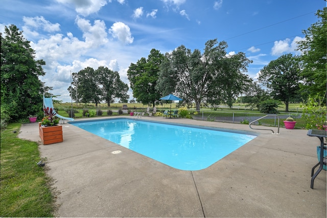 view of swimming pool featuring a patio area