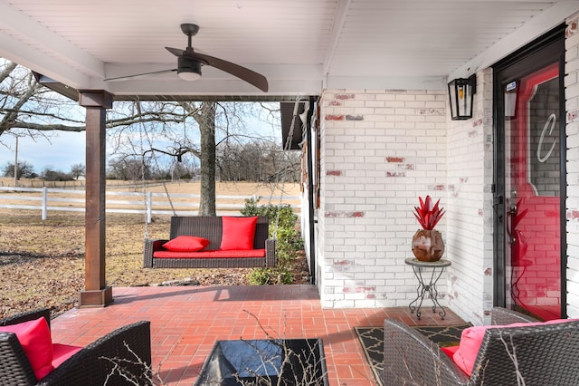 view of patio featuring fence and ceiling fan