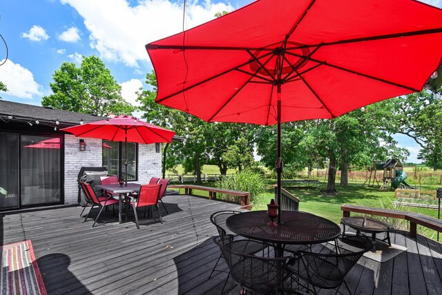 15778 Lawrence Unit 2130, Mount Vernon, MO 65712 - wooden deck featuring outdoor dining area and a playground