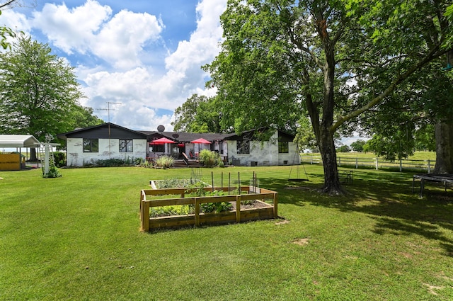 15778 Lawrence Unit 2130, Mount Vernon, MO 65712 - view of yard featuring a trampoline and a vegetable garden