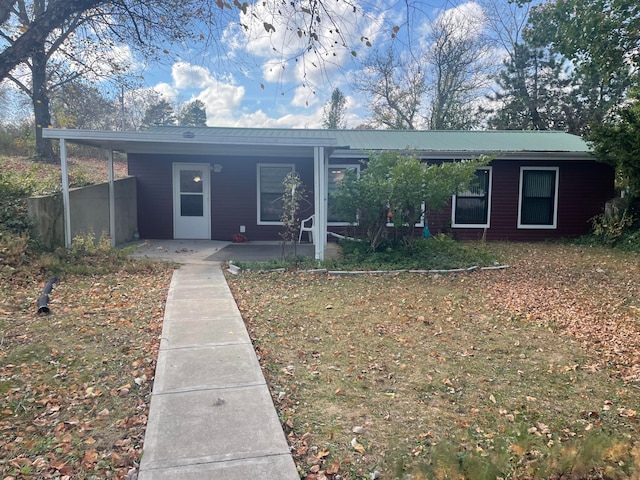 single story home featuring a carport