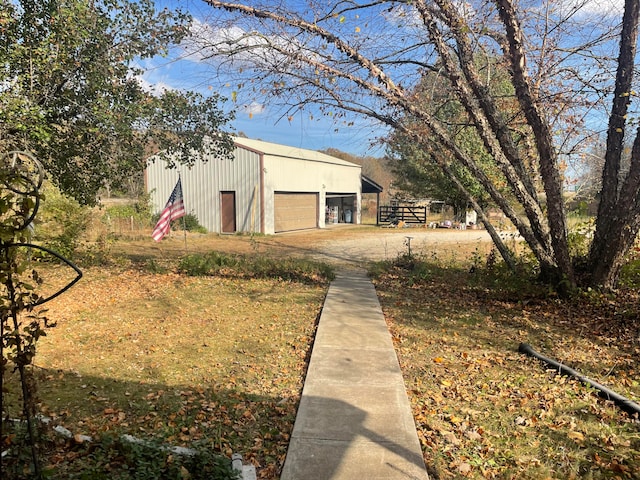 view of property exterior featuring a garage and an outdoor structure