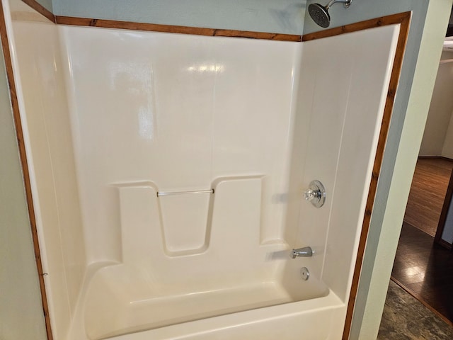 bathroom with shower / bath combination and wood-type flooring