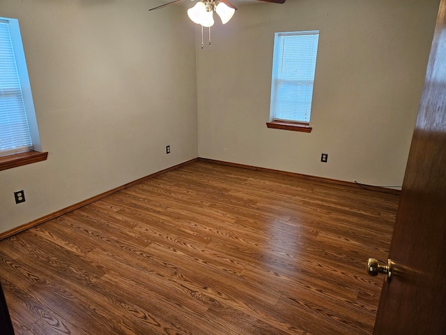 empty room with ceiling fan and hardwood / wood-style floors