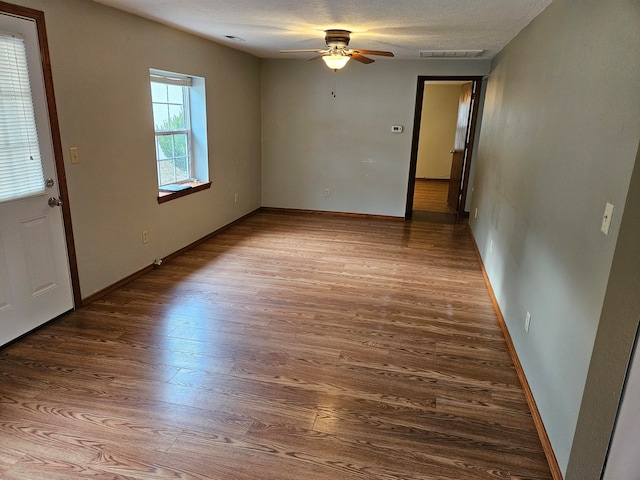 spare room featuring a textured ceiling, hardwood / wood-style flooring, and ceiling fan