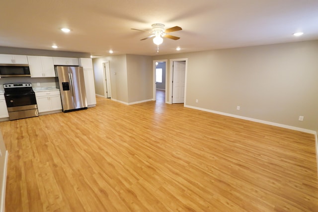 kitchen featuring white cabinetry, ceiling fan, appliances with stainless steel finishes, and light hardwood / wood-style flooring