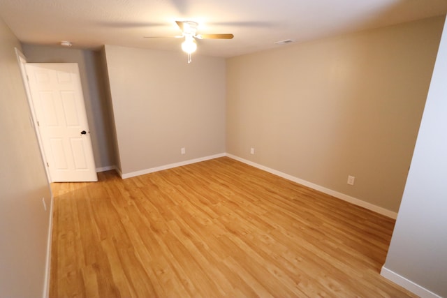 spare room featuring light wood-type flooring and ceiling fan