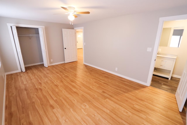 unfurnished bedroom with light hardwood / wood-style flooring, a closet, and ceiling fan