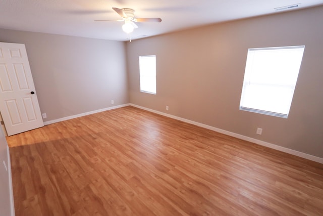 empty room with light hardwood / wood-style flooring and ceiling fan