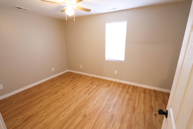 empty room with light hardwood / wood-style flooring and ceiling fan