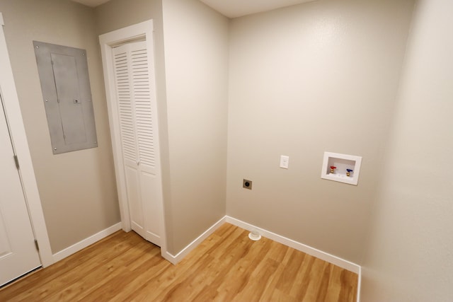 clothes washing area with hookup for an electric dryer, electric panel, washer hookup, and wood-type flooring