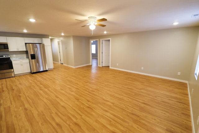 kitchen featuring appliances with stainless steel finishes, light hardwood / wood-style flooring, white cabinets, and ceiling fan