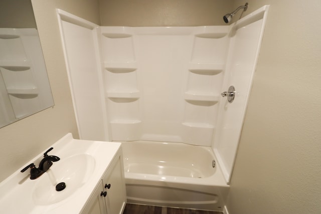 bathroom featuring vanity, shower / bathing tub combination, and hardwood / wood-style floors