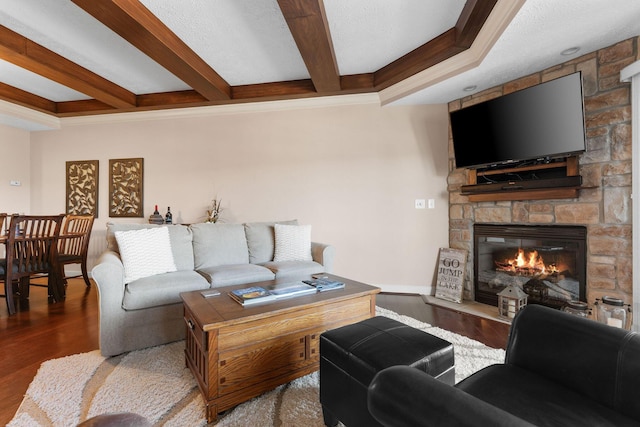 250 Lakewood Dr Unit 6303, Hollister, MO 65672 - living area with a stone fireplace, wood finished floors, beam ceiling, crown molding, and baseboards