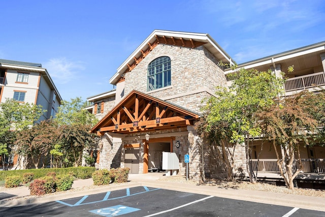 250 Lakewood Dr Unit 6303, Hollister, MO 65672 - view of property featuring uncovered parking and an attached garage