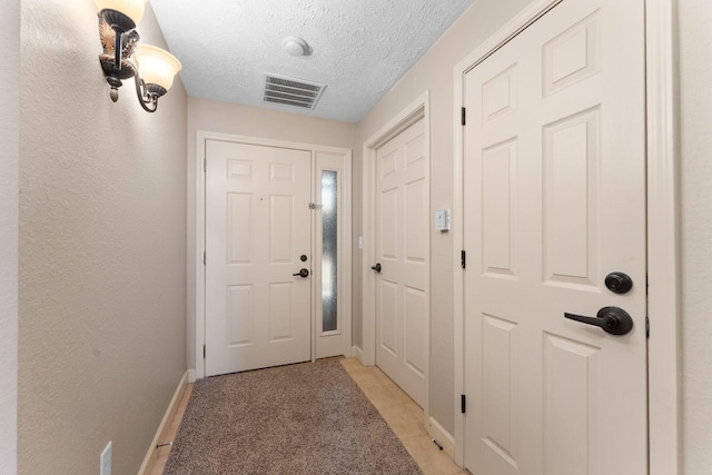 250 Lakewood Dr Unit 6303, Hollister, MO 65672 - entryway featuring a textured ceiling and baseboards