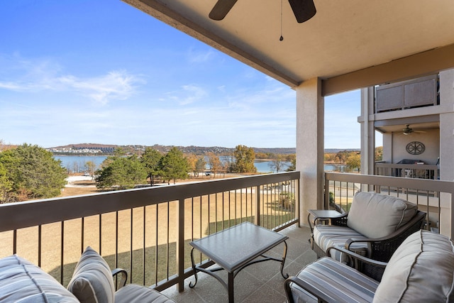 balcony with a water view and ceiling fan