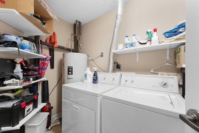 washroom featuring a textured ceiling, water heater, and washing machine and dryer