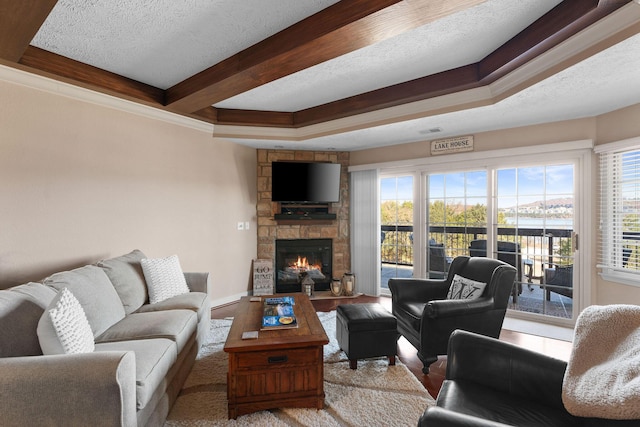 250 Lakewood Dr Unit 6303, Hollister, MO 65672 - living area featuring a stone fireplace, wood finished floors, a textured ceiling, beam ceiling, and baseboards