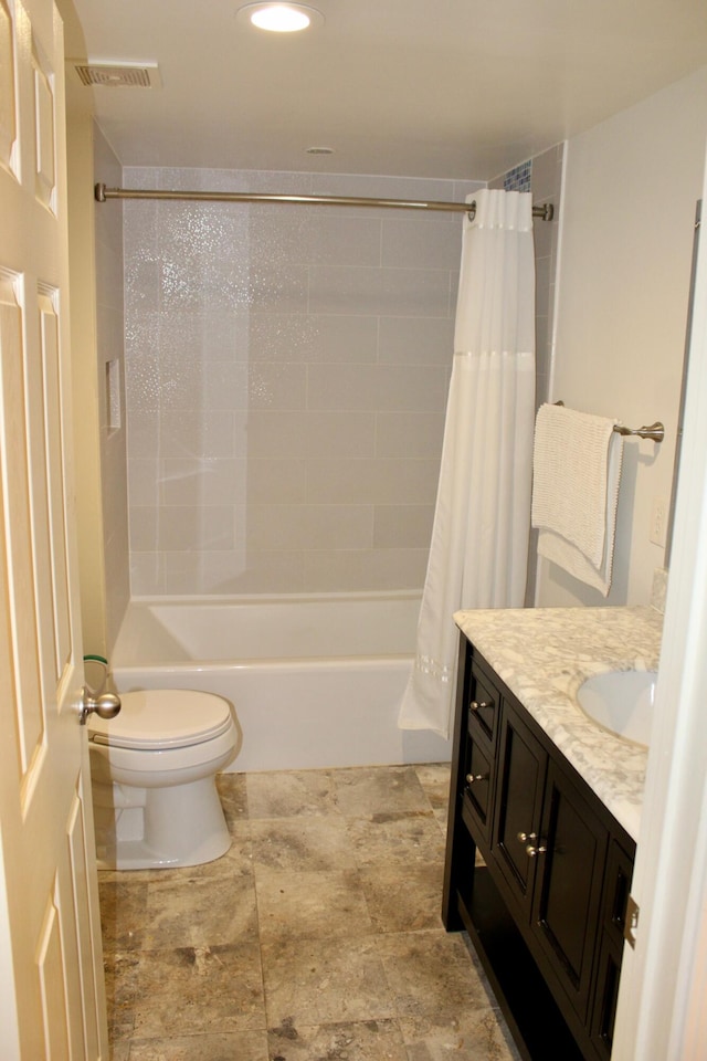 full bathroom featuring vanity, toilet, and shower / bath combination with curtain