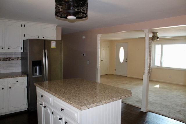 kitchen featuring a center island, white cabinetry, dark wood-type flooring, decorative backsplash, and stainless steel refrigerator with ice dispenser