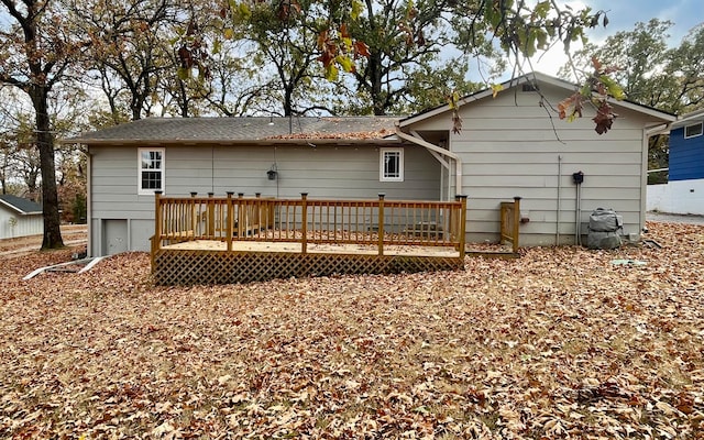 back of property featuring a wooden deck