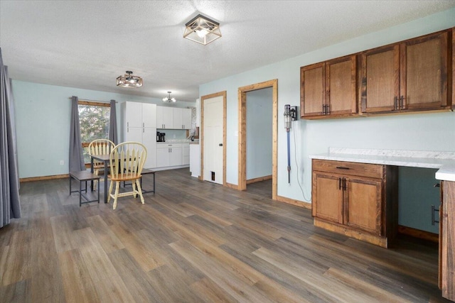 kitchen with dark wood-type flooring and a textured ceiling