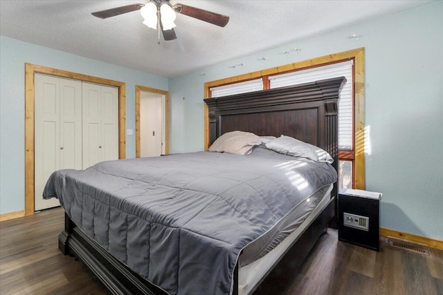 bedroom with a textured ceiling, dark hardwood / wood-style floors, a closet, and ceiling fan