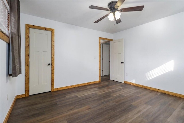 unfurnished room with ceiling fan and dark hardwood / wood-style flooring