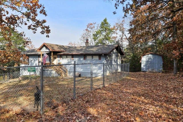 single story home featuring a shed