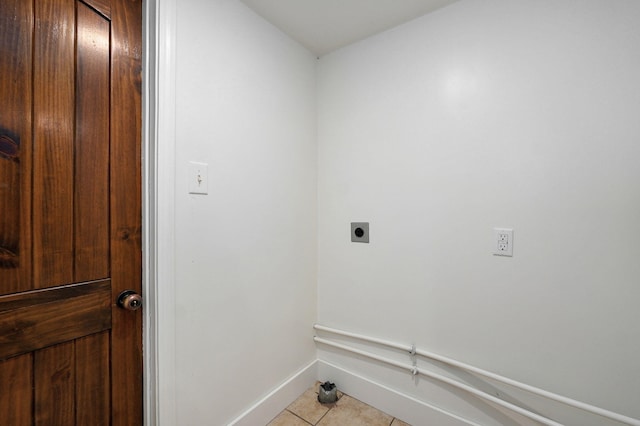 clothes washing area featuring hookup for an electric dryer and light tile patterned floors