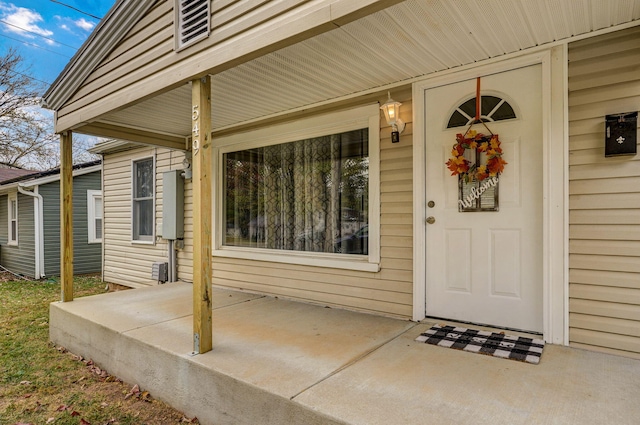 view of exterior entry with a patio