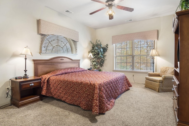 bedroom featuring light colored carpet and ceiling fan