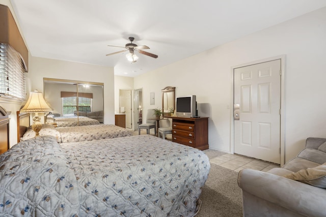 tiled bedroom featuring ceiling fan