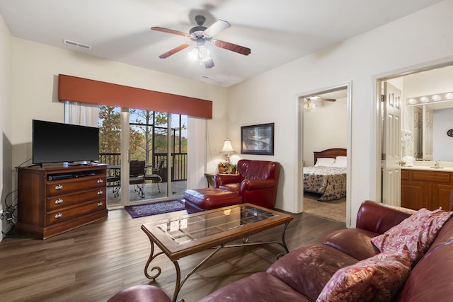 living room with sink, dark wood-type flooring, and ceiling fan