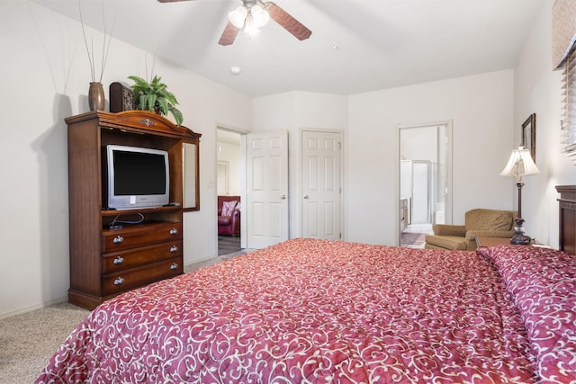 carpeted bedroom featuring connected bathroom and ceiling fan