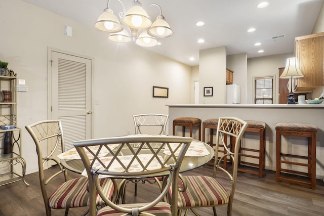 dining room with a notable chandelier and dark hardwood / wood-style flooring