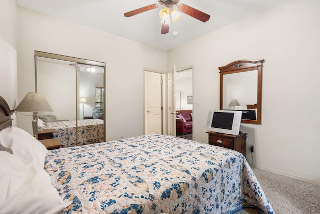 carpeted bedroom featuring a closet and ceiling fan